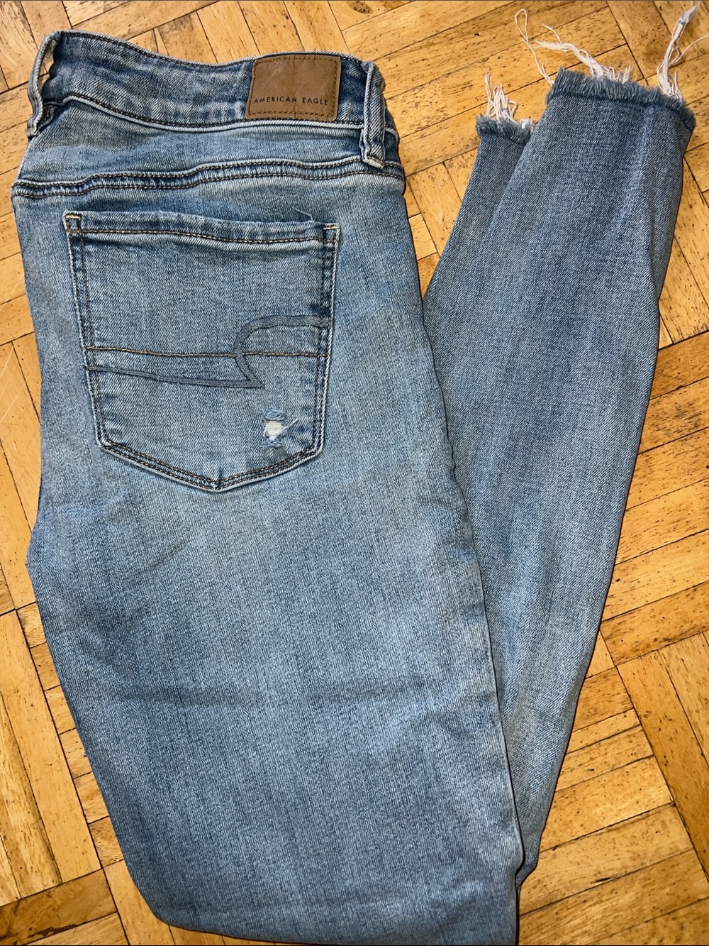 American Eagle Outfitters Light Wash Blue Denim Jeggings with Frayed Ankles